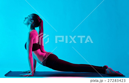woman yoga exercices Bhujangasana cobra pose woman yoga exercices Bhujangasana cobra pose 27283423