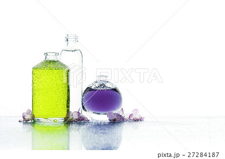 Three bottles with color liquid and flowers Three bottles with color liquid and flowers 27284187