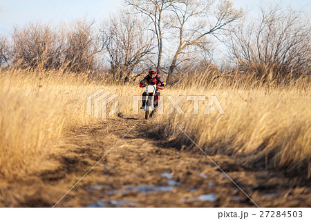 Enduro bike rider on a field in autumn 27284503