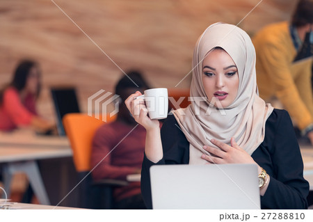 Arabic business woman wearing hijab,working in 27288810