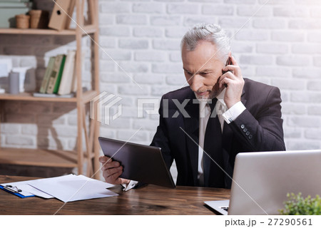 Focused positive executive making a phone call Focused positive executive making a phone call 27290561