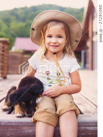 Cute little girl hugging dog puppy 27291060
