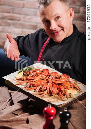 Overjoyed man demonstrating a tray full of Overjoyed man demonstrating a tray full of 27291930