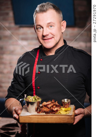 Surprised man holding a tray with bacon 27291970
