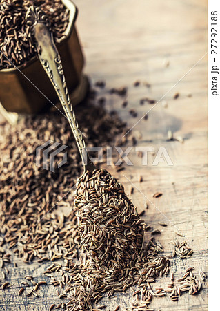 Cumin.Caraway seeds on wooden table.Cumin in bowl. 27292188