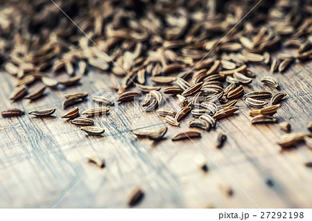 Cumin.Caraway seeds on wooden table.Cumin in bowl. Cumin.Caraway seeds on wooden table.Cumin in bowl. 27292198