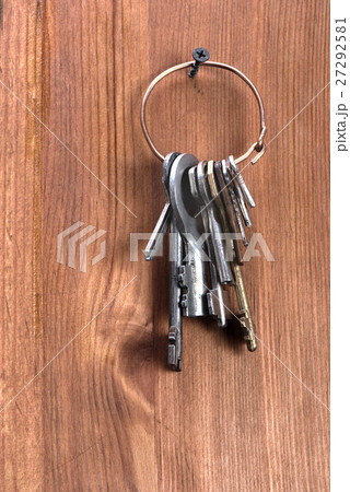 keys hanging on a wooden wall 27292581
