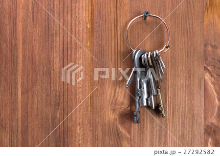 keys hanging on a wooden wall 27292582
