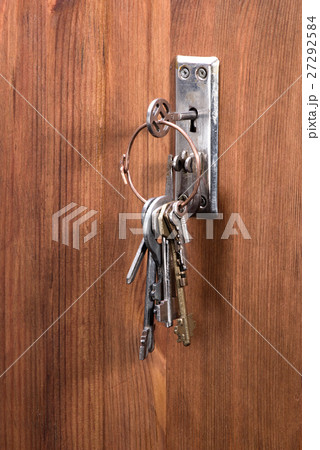 retro key on bunch is inserted into the keyhole 27292584