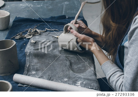 Young business owner working with clay mug Young business owner working with clay mug 27293336