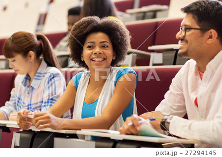 group of students with notebooks in lecture hall group of students with notebooks in lecture hall 27294145