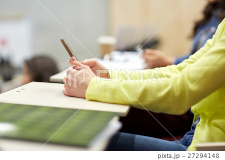 close up of student with smartphones on lecture 27294148