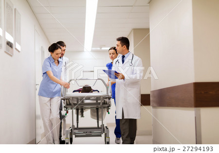 medics with woman on hospital gurney at emergency 27294193