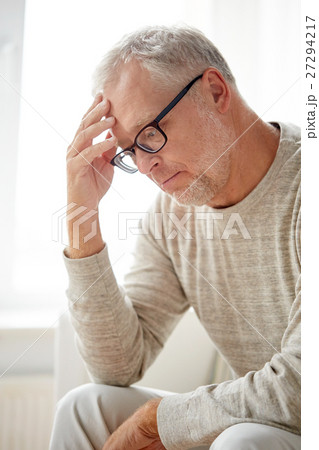 senior man suffering from headache at home 27294217