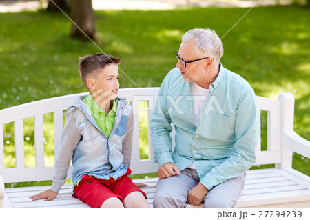 grandfather and grandson talking at summer park 27294239