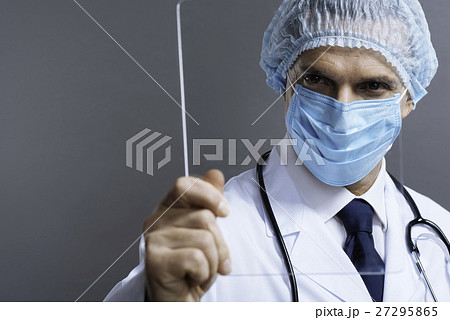 Attractive doctor in face mask holding a glass 27295865