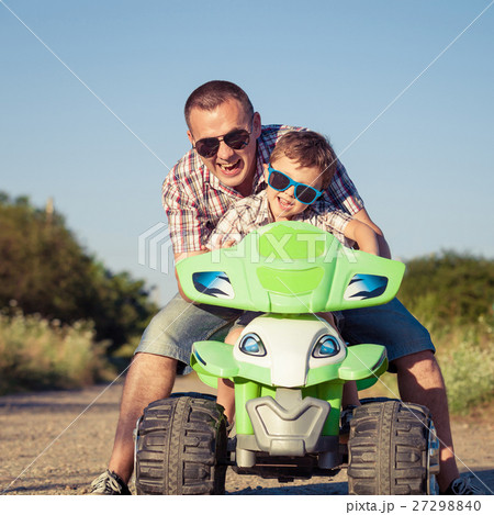 Father and son playing on the road at the day time. 27298840