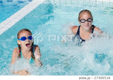 Two happy children playing on the swimming pool at the day time. Two happy children playing on the swimming pool at the day time. 27300518