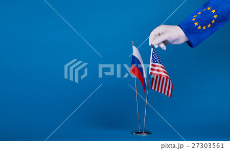 Two flags and hand on a blue background, Two flags and hand on a blue background, 27303561