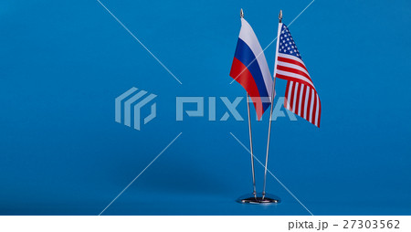Two flags and hand on a blue background, 27303562