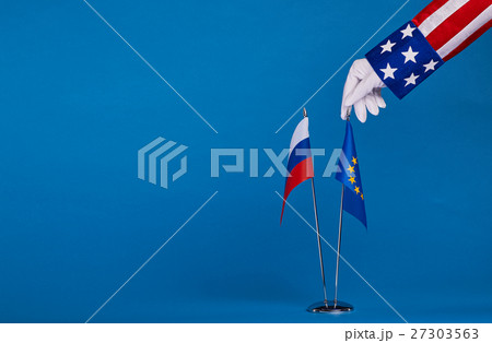 Two flags and hand on a blue background, Two flags and hand on a blue background, 27303563