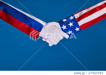 Two flags and hand on a blue background, Two flags and hand on a blue background, 27303565