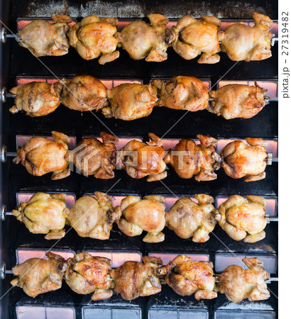 Juicy chicken grilled on rolling spit in store Juicy chicken grilled on rolling spit in store 27319482
