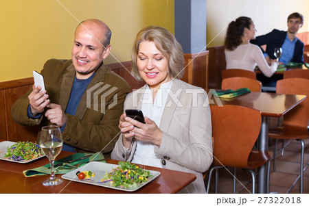Couple taking photoes of meal . Couple taking photoes of meal . 27322018