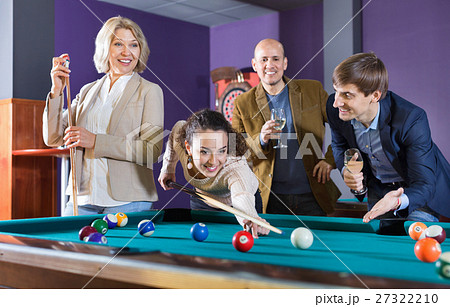 Group of cheerful pretty positive friends playing billiards Group of cheerful pretty positive friends playing billiards 27322210