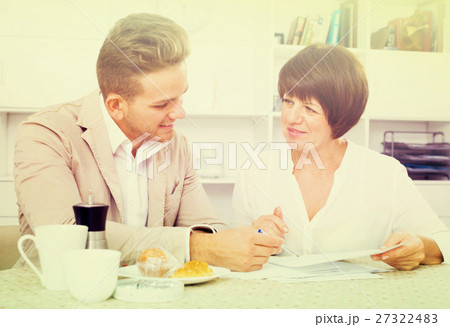 Man and woman with cups coffee and documents Man and woman with cups coffee and documents 27322483