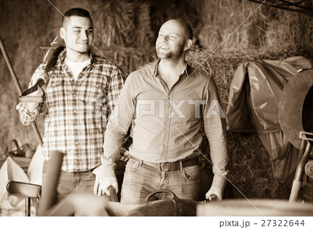 Ranchers working in a granary 27322644