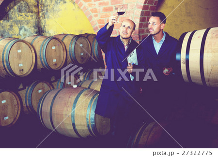 Winery employees checking up wine sample Winery employees checking up wine sample 27322775