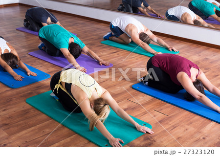 People relaxing and enjoying yoga People relaxing and enjoying yoga 27323120