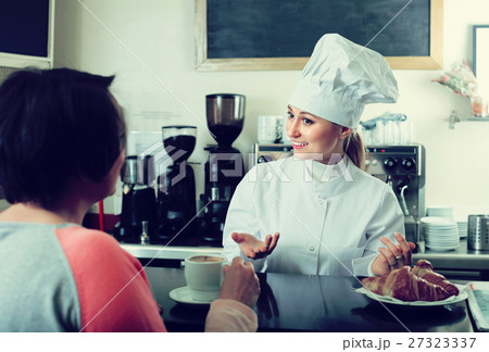 Girl offering desserts in the pastry shop . Girl offering desserts in the pastry shop . 27323337