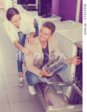 Family selecting modern dishwasher 27323398