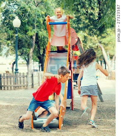 children having fun on slide at playground. children having fun on slide at playground. 27323587