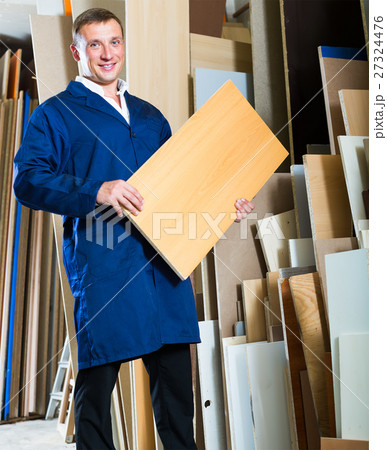 young workman standing with plywood pieces young workman standing with plywood pieces 27324476