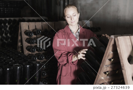 Laughing woman winery employee working in cellar 27324639