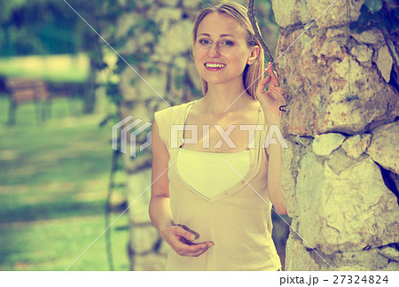 Portrait of glad young blond woman in garden 27324824