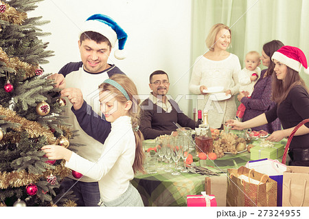 Happy family with Christmas tree at home. 27324955