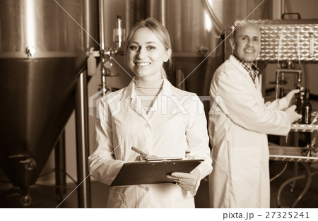 Two brewery workers on beer factory. Two brewery workers on beer factory. 27325241