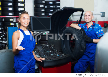 Two positive technicians working in car service 27325650