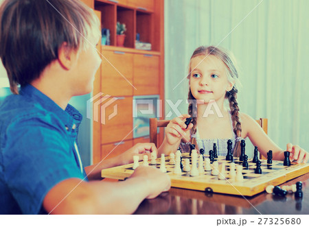 children at chess board indoors children at chess board indoors 27325680