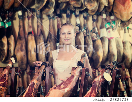 Woman picking delicious prosciutto meat 27325733