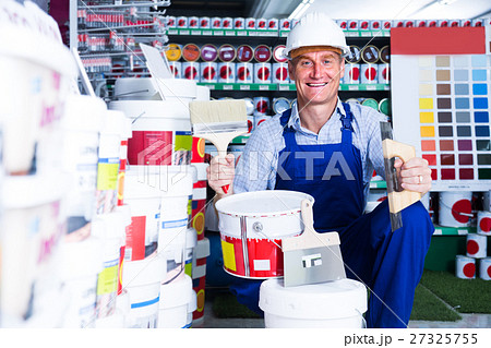 man choosing paint bucket 27325755