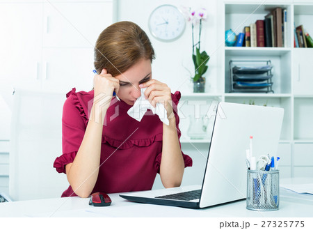 Tired woman crying at work Tired woman crying at work 27325775