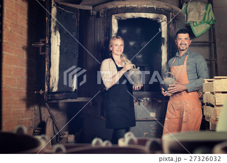 potters holding black ceramic vases potters holding black ceramic vases 27326032