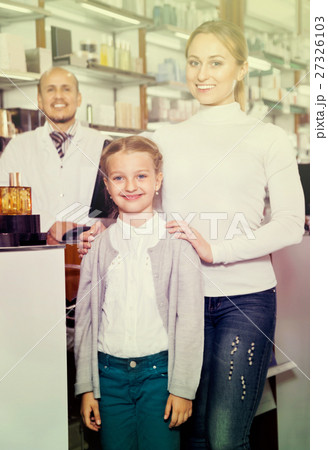 Male pharmacist working pharmaceutical store and consulting customers 27326103