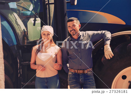 Two farmers near field engine 27326181