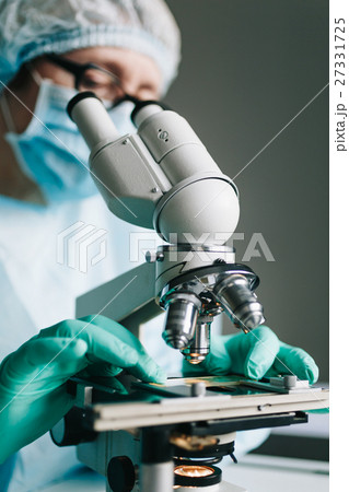 Scientist working in laboratory with microscope Scientist working in laboratory with microscope 27331725
